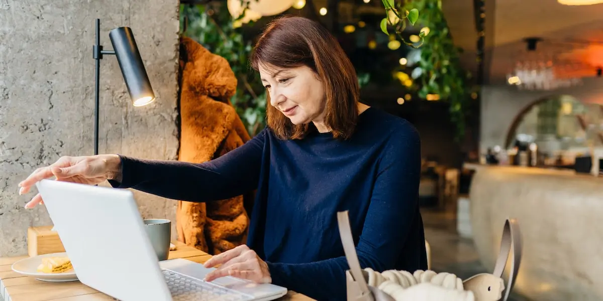 Woman working from laptop in a coworking space as part of a hybrid work model
