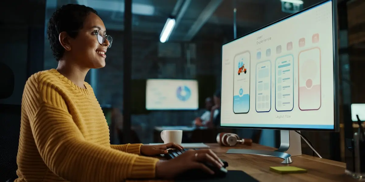 ux designer working at a computer uses a principle of design in a ux design