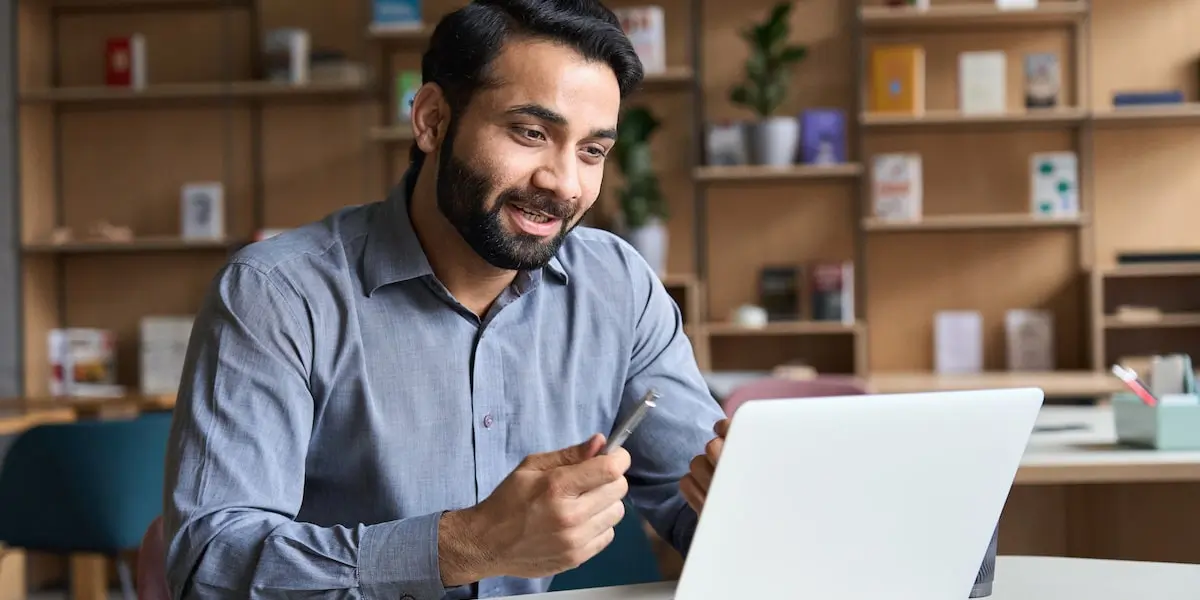 A software engineer practices technical interview questions on his laptop.