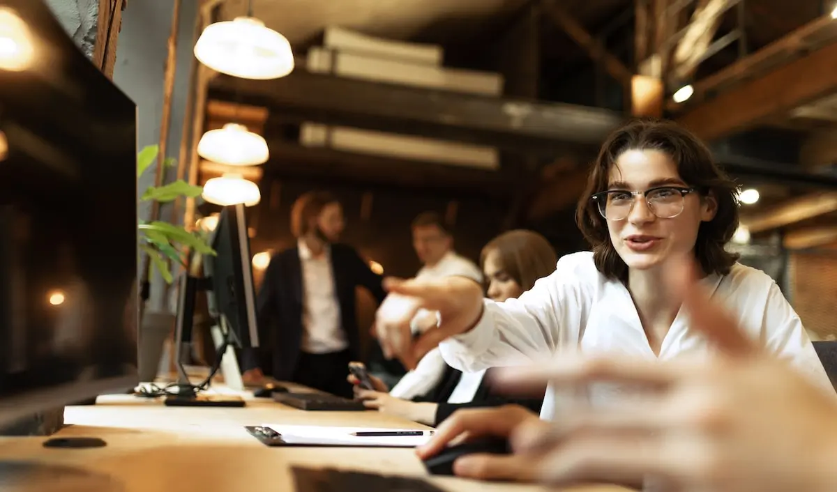 some of the skills coders need may surprise you A coder communicates to a colleague in a start-up office.