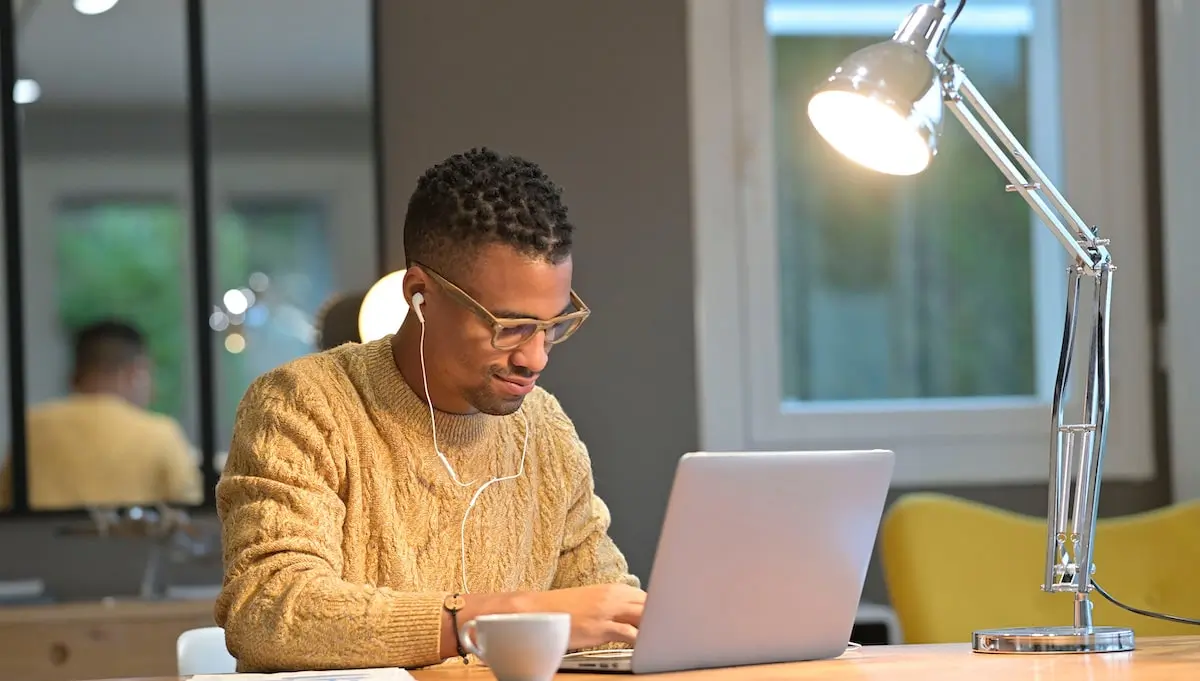A JavaScript developer works remotely on his laptop.