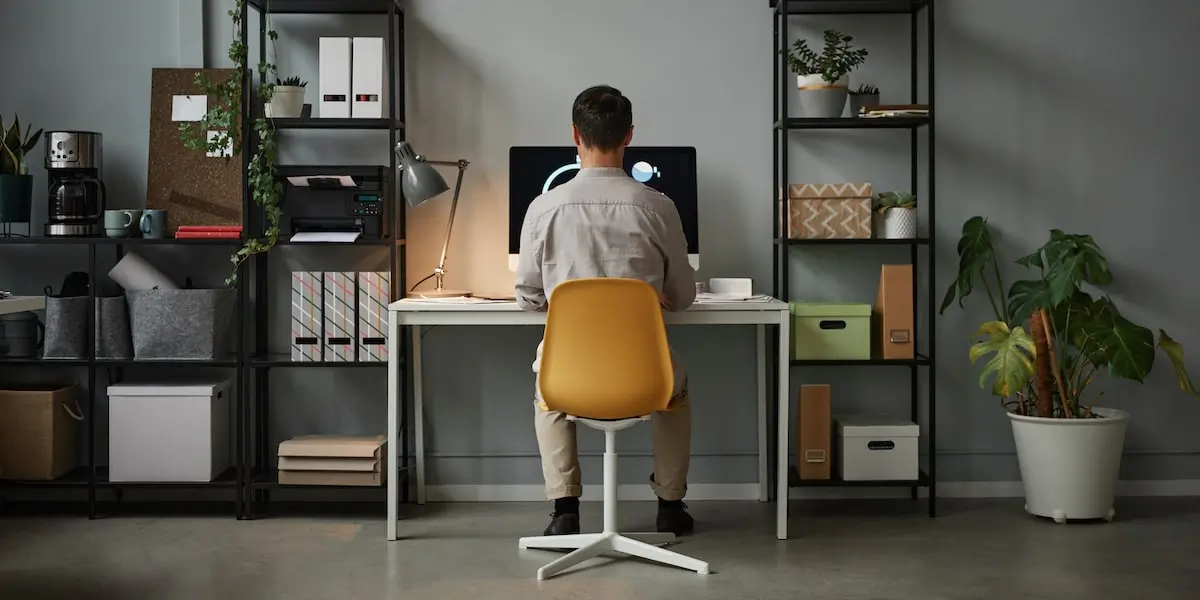 remote coding from home A man taking coding bootcamps with job guarantee in his home office.