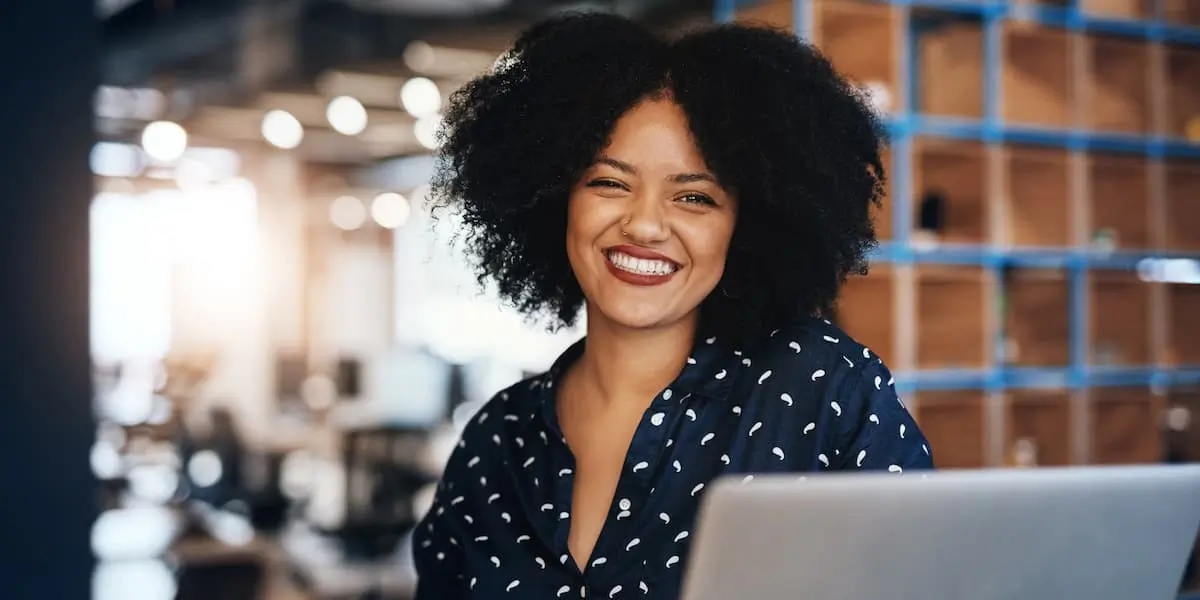 A career changer at her laptop researches why UX design is a great career