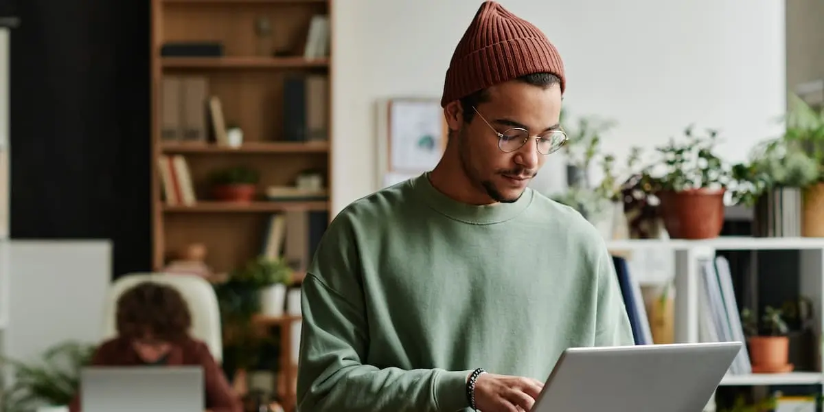 a ux writer using scannability to improve a webpage looks at the result on his laptop