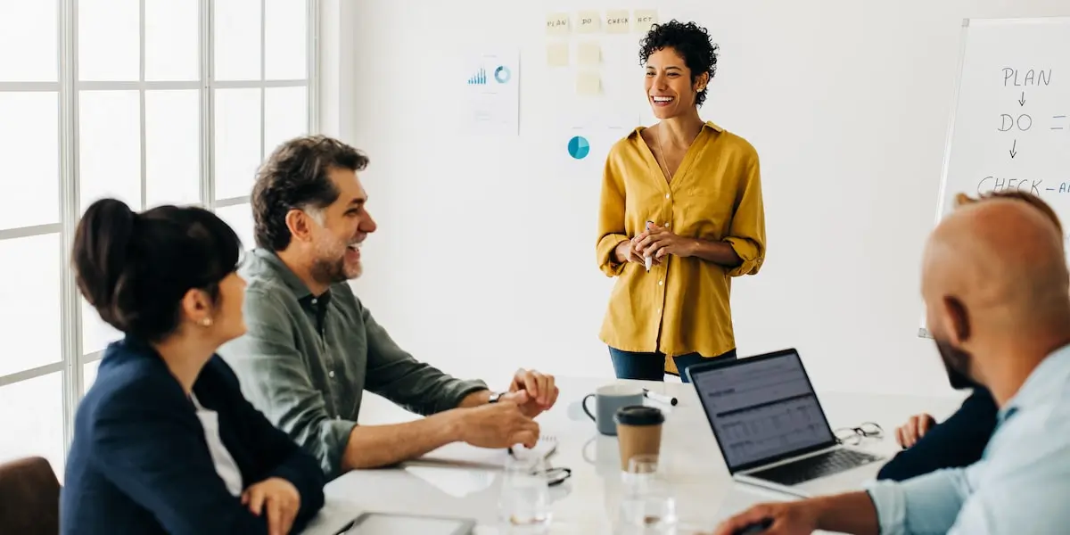 A product marketing manager presents the company's product mix to colleagues in a boardroom.