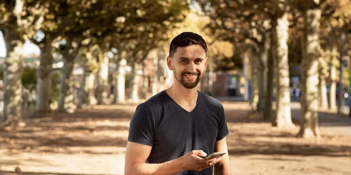 germany has a great quality of life Software engineer standing smiling in a park in Germany.