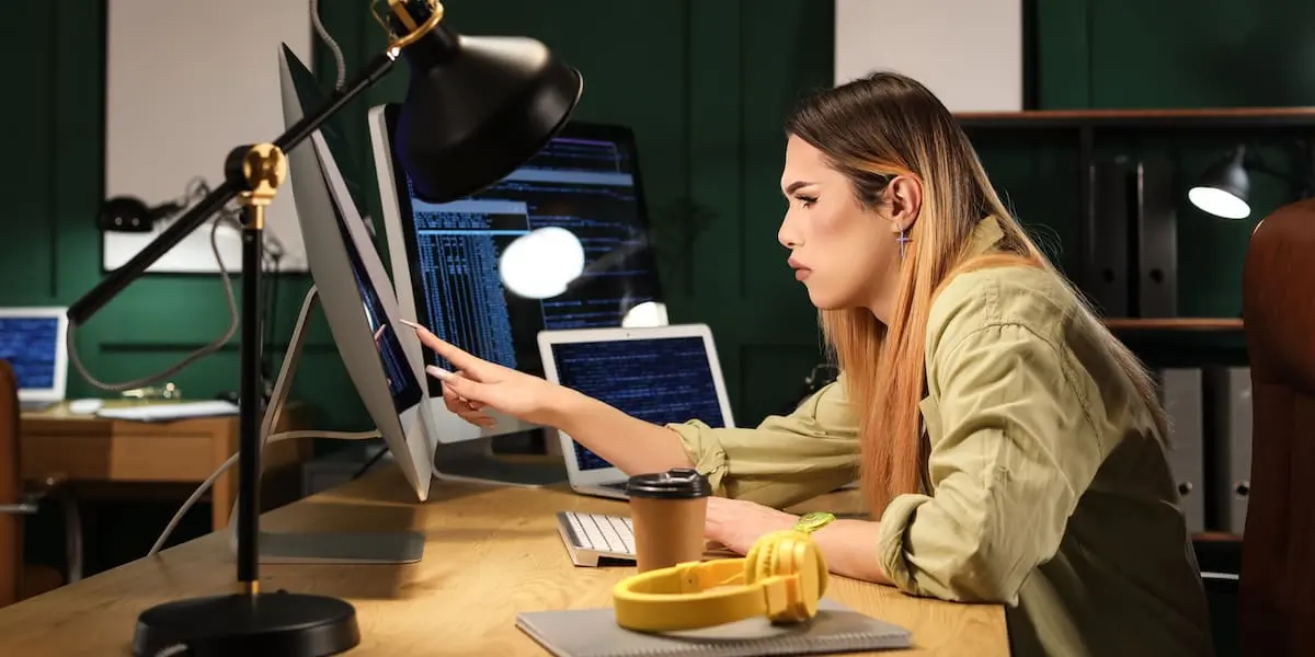 A programmer codes at their desk.