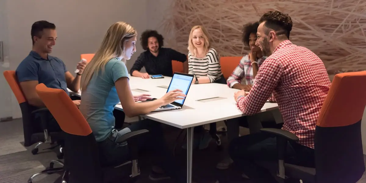 A team of developers employing the Waterfall SDLC system in a meeting.