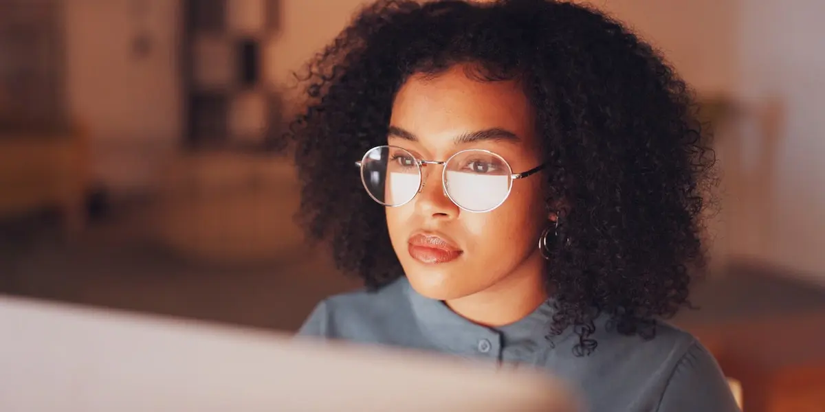 Worker looking at computer considers AI ethics in her business