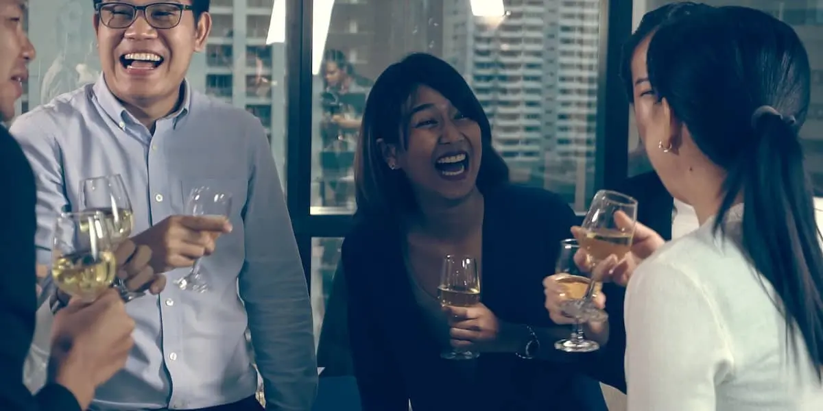 dont forget to celebrate your product launch A team with glasses of liquid celebrating a product launch.