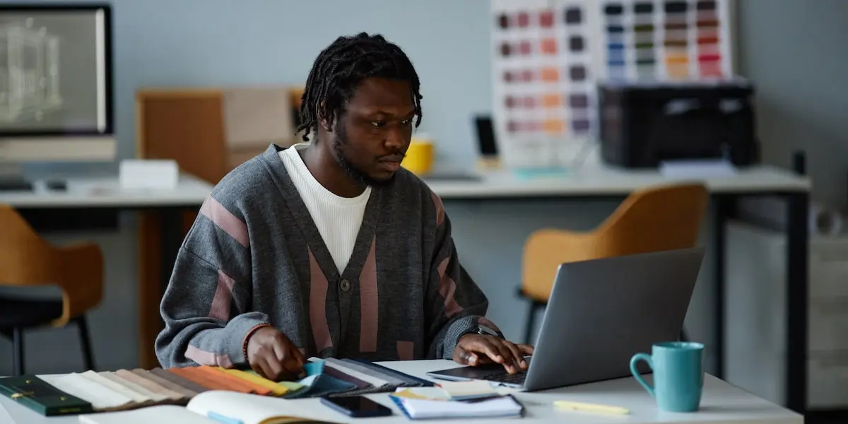 A product designer searches through color swatches in an office.
