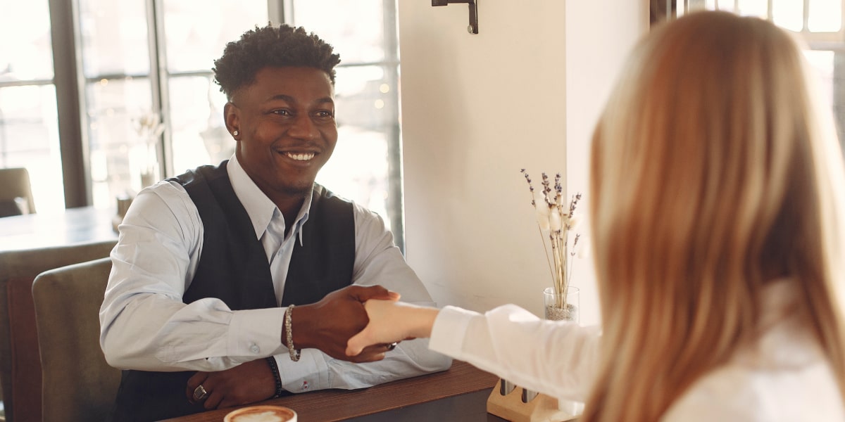 A UX design hiring manager interviewing a bootcamp graduate