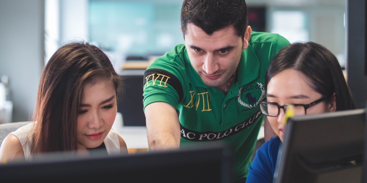 A developer collaborating with two designers on a project