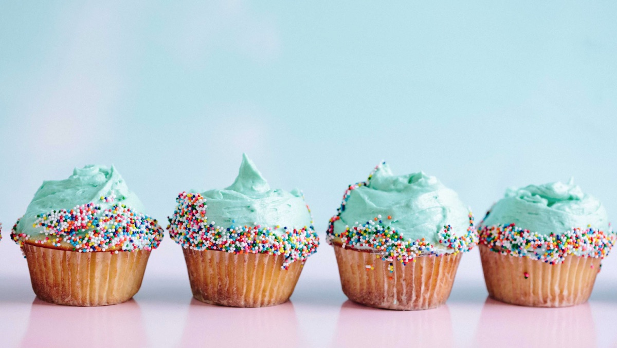 A row of four almost identically decorated cupcakes