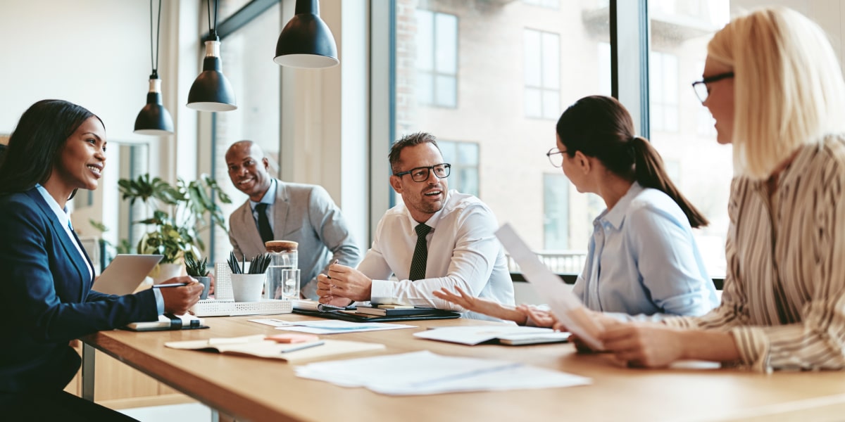 A group of data scientists sitting in an office, around a table