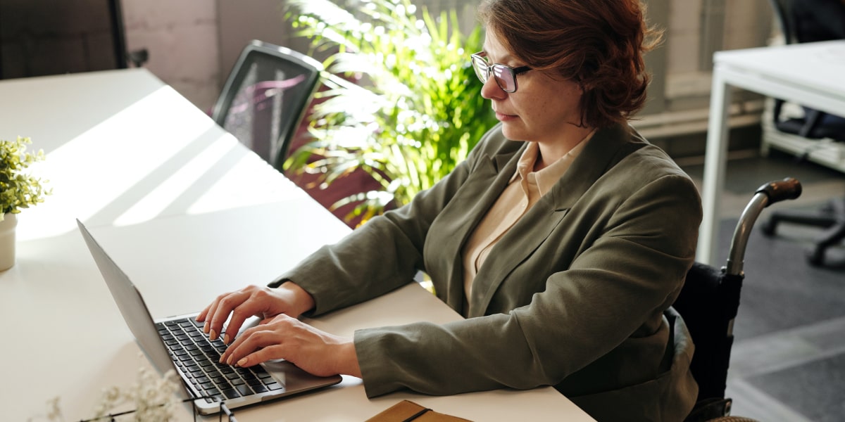 There's a huge amount of flexibility in work for full-stack developers Female full-stack developer sits at a desk working at a laptop in her wheelchair