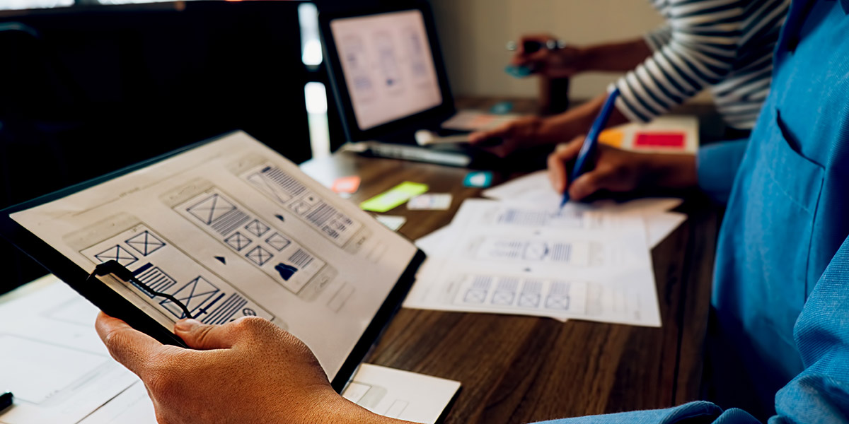 A designer sketching out a wireframe A designer sketches out a wireframe as part of ideation