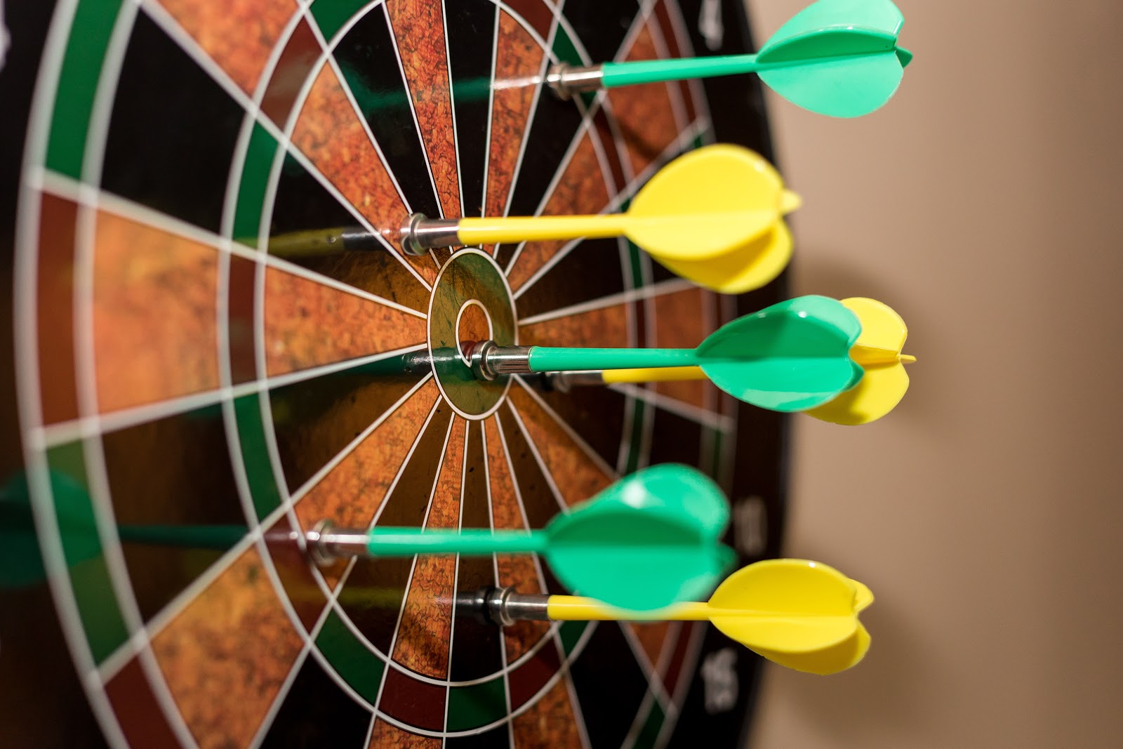 How to Write an Amazing Product Page: Main Focus Darts embedded in a dartboard
