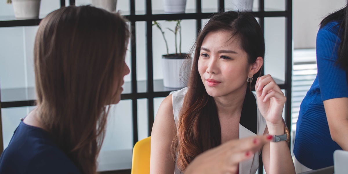 Qualitative vs. Quantitative UX Research A UX researcher conversing with a user, gathering qualitative data