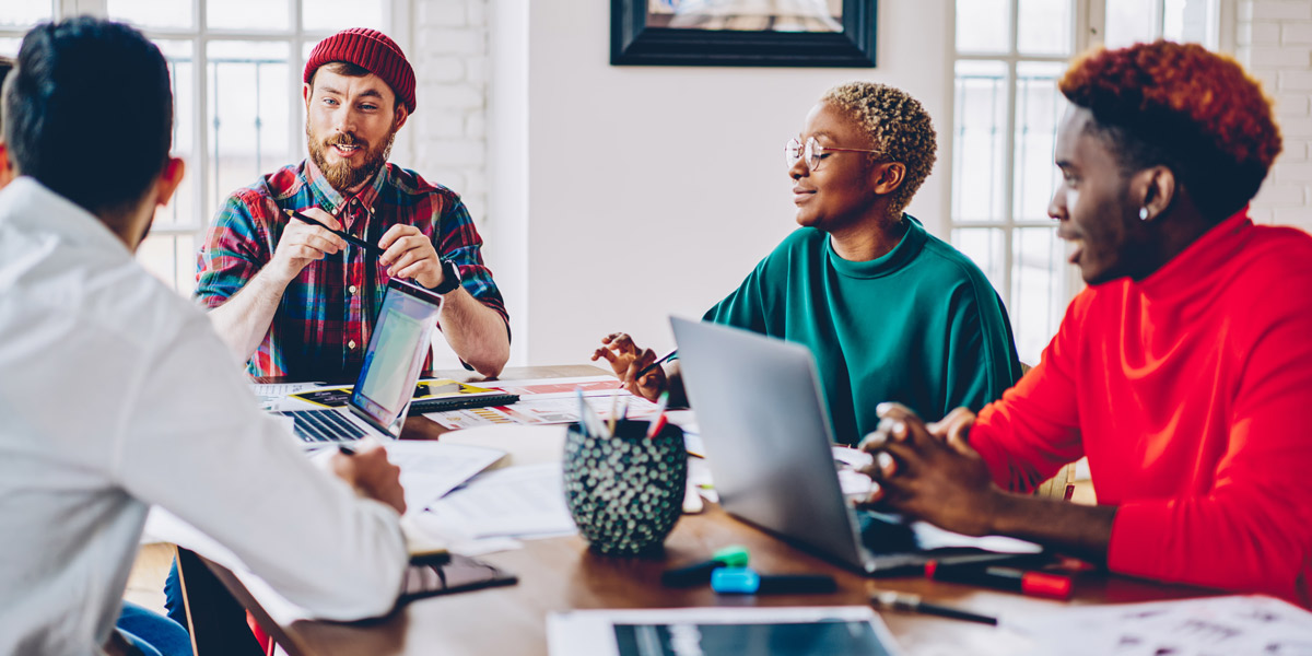 A group of designers sitting around a table, talking