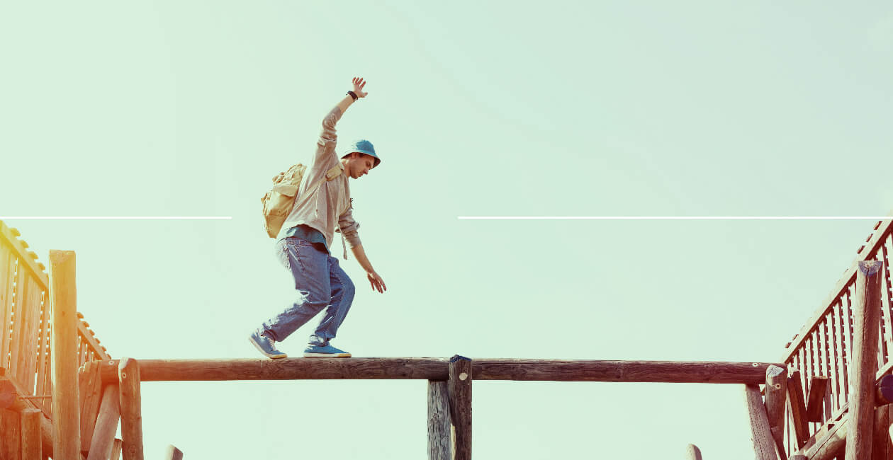 A freelancer walking a tightrope to symbolize risk