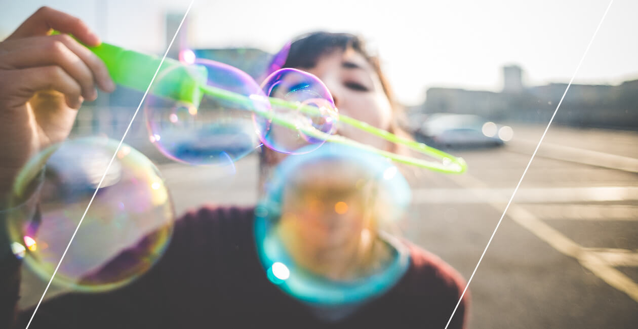 A woman blowing bubbles, symbolizing fun and freedom
