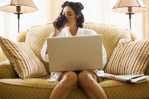 Woman working from home, sipping a coffee Woman working from home, sipping a coffee