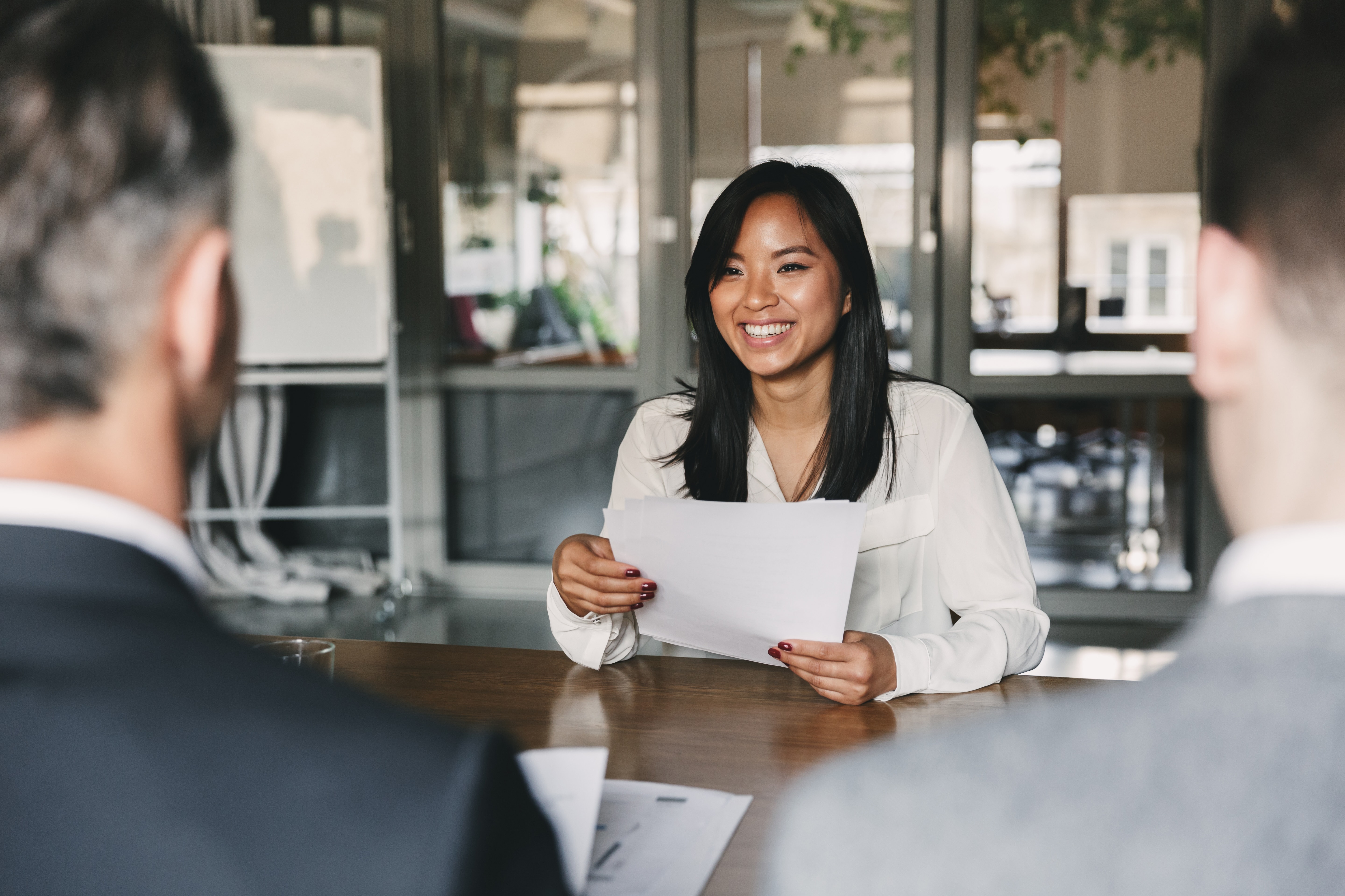 Woman sat at a table attending a job interview