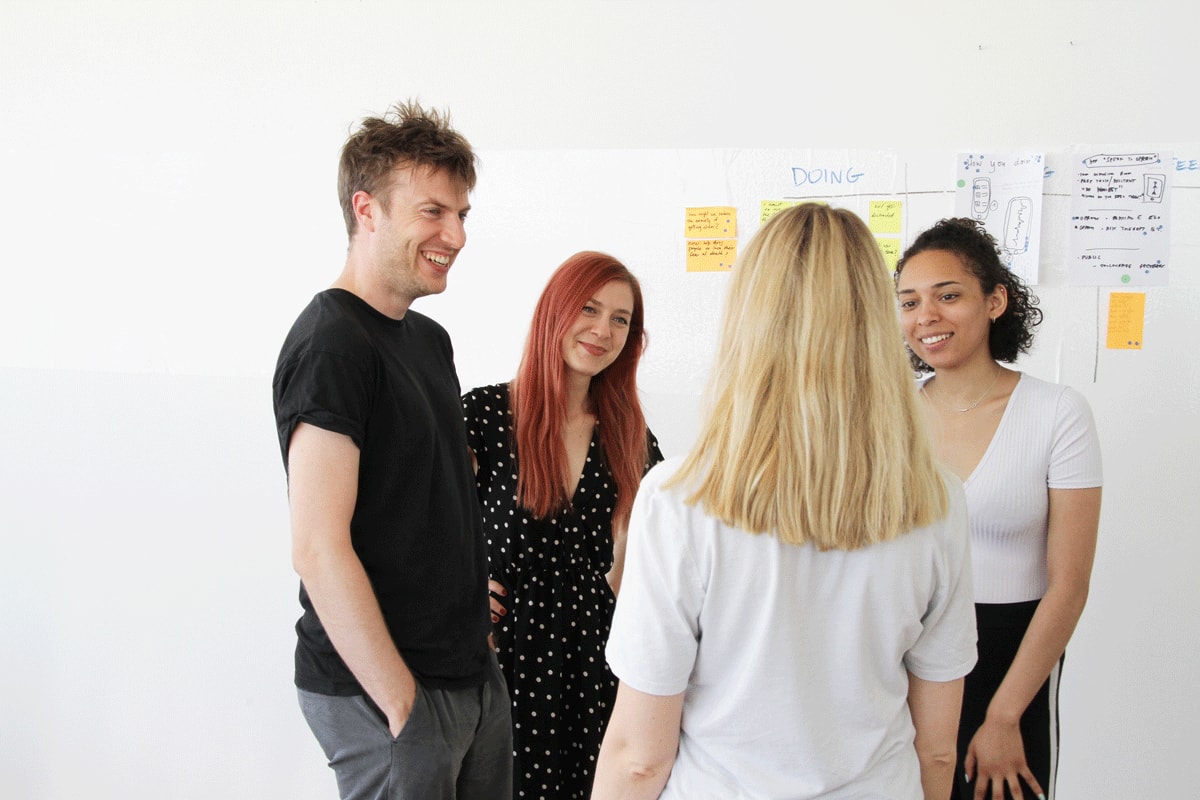 Four professionals taking part in an ice-breaker activity